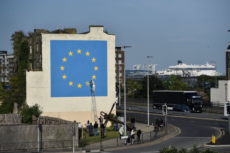 An artwork attributed to street artist Banksy, depicting a workman chipping away at one of the 12 stars on the flag of the European Union, is seen on a wall in the ferry port of Dover, Britain May 7, 2017. REUTERS/Hannah McKay FOR EDITORIAL USE ONLY. NO RESALES. NO ARCHIVES.