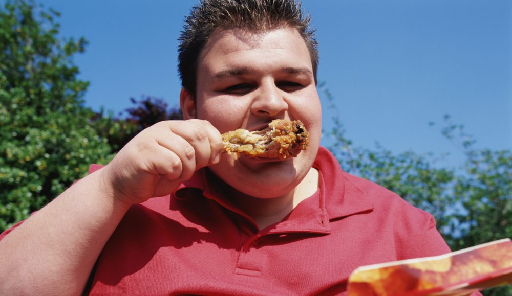 Man eating chicken