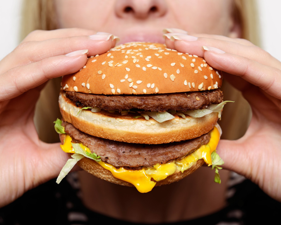 Woman eating big mac