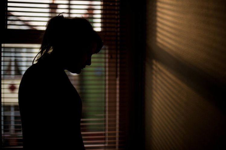 Silhouette of woman by window