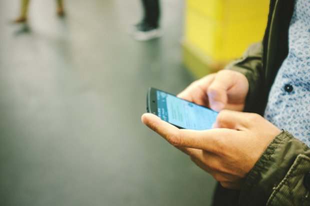 Cropped Image Of Man Text Messaging At Hermannplatz