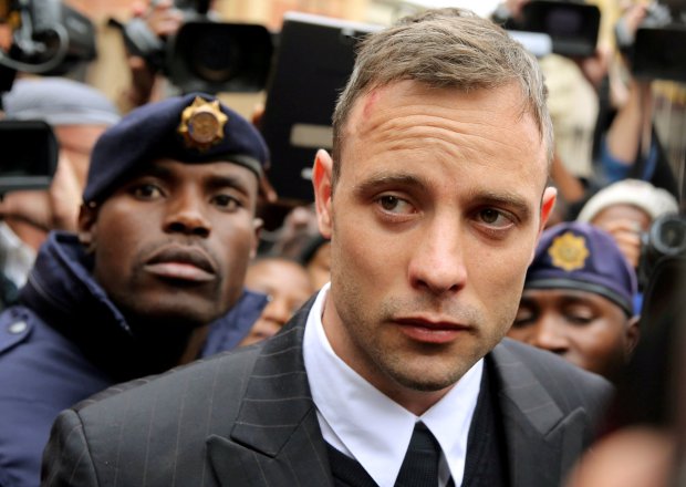 FILE PHOTO: Olympic and Paralympic track star Oscar Pistorius leaves court after appearing for the 2013 killing of his girlfriend Reeva Steenkamp