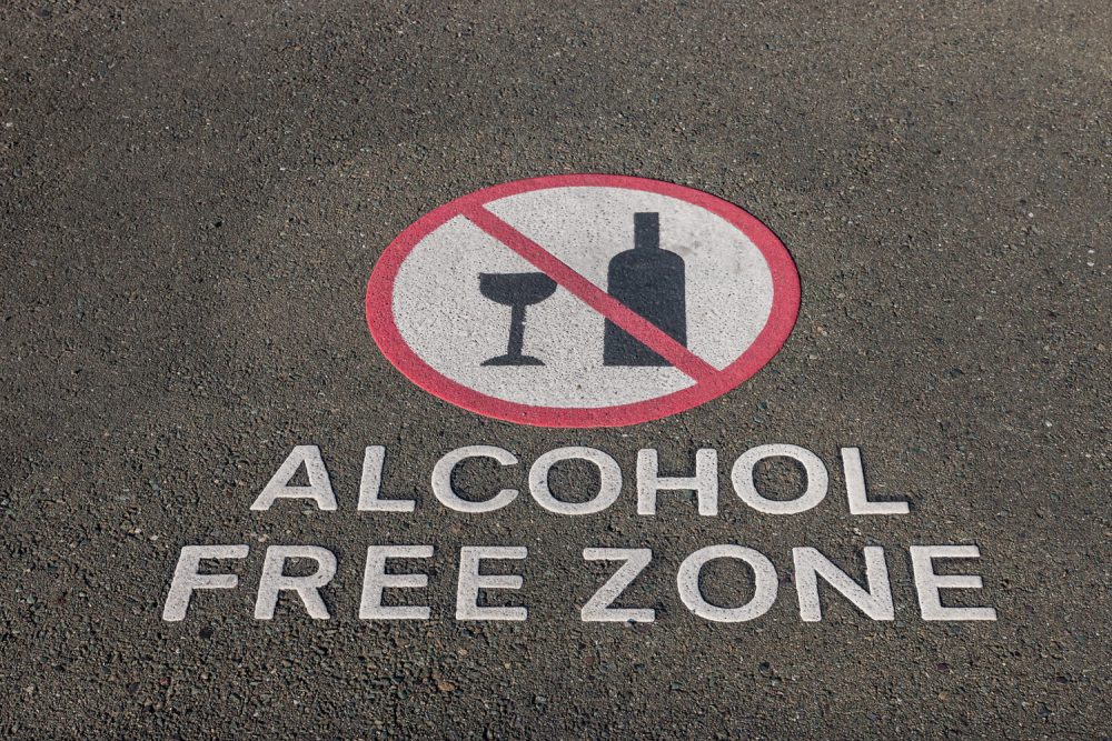 alcohol free zone sign on pavement