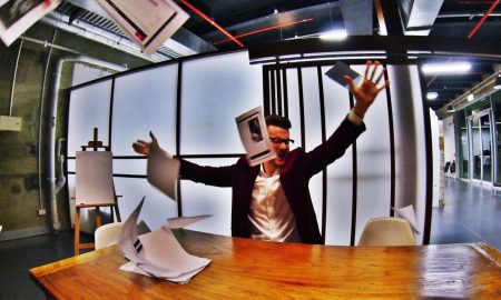 Business man throwing paperwork in frustration