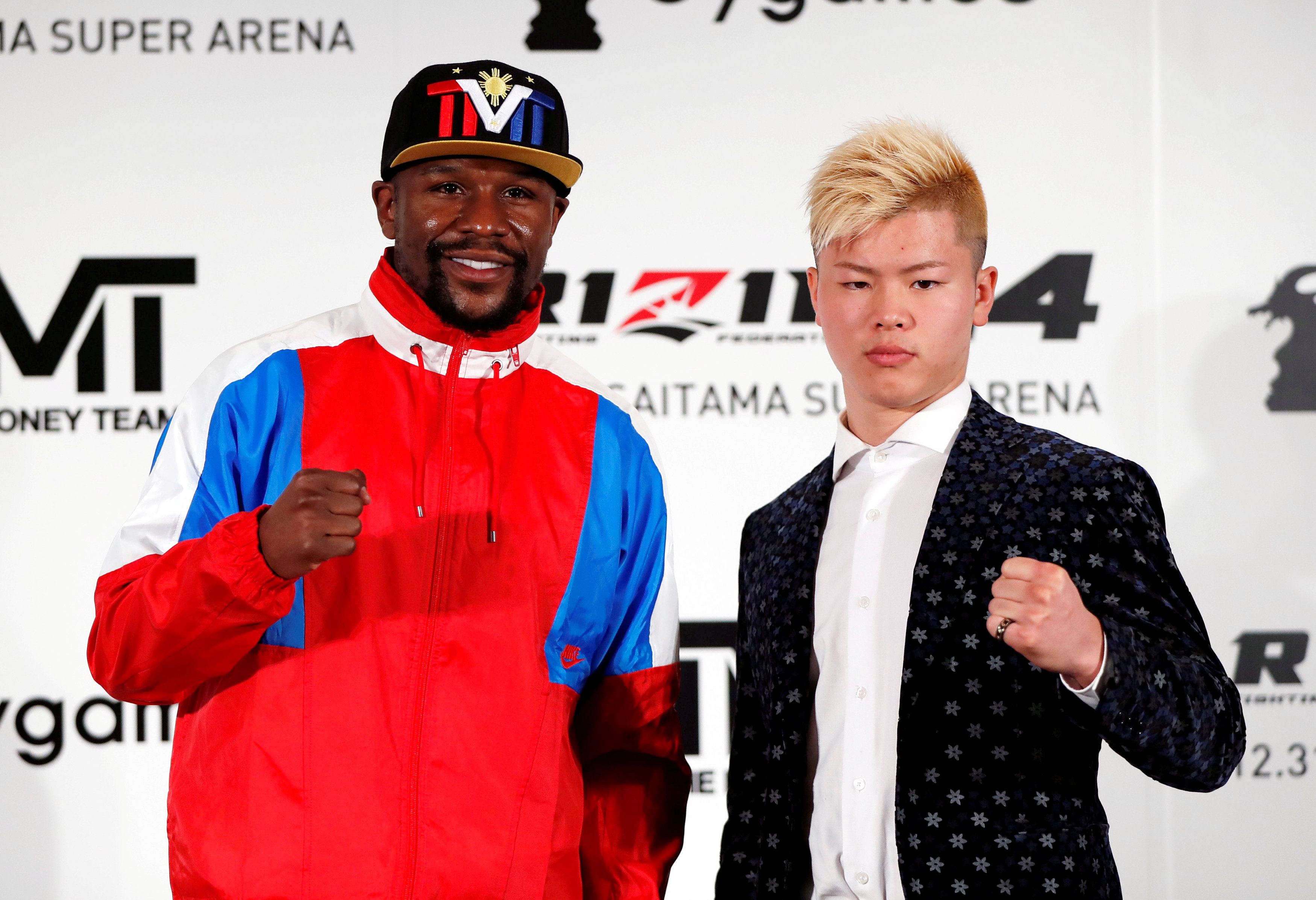 Boxer Floyd Mayweather Jr. of the U.S. poses for a photograph with his opponent Tenshin Nasukawa during a news conference in Tokyo