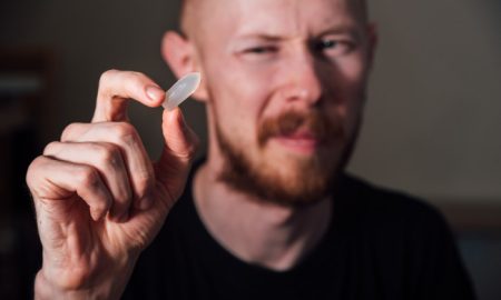 Sad young man holding suppository