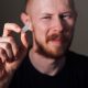 Sad young man holding suppository