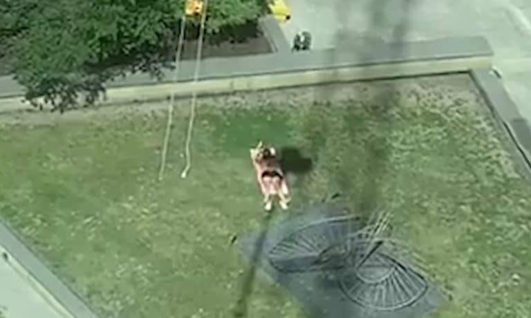 Watch This Crane Driver Manoeuvre His Crane To Block A Hipster Sunbathing