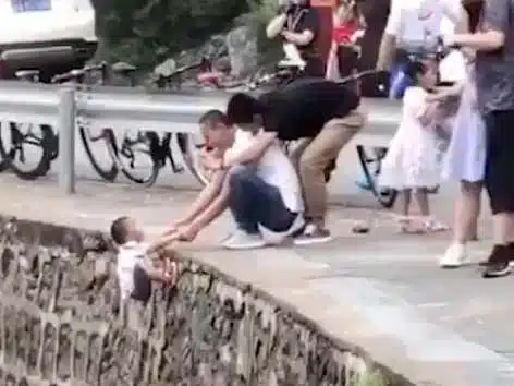Dad Of The Year Hangs Son Off A Cliff To Take Photo (VIDEO)