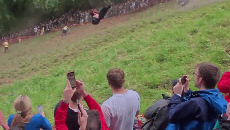 Man Goes Absolutely FLYING In Front Of Thousands Of People At The Annual Gloucestershire Cheese Rolling Race